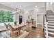 Bright dining room with wood table, large windows and modern chandelier at 5588 Rhododendron Trl, Douglasville, GA 30135