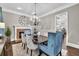 Elegant dining room featuring a brick fireplace and stylish chandelier at 5588 Rhododendron Trl, Douglasville, GA 30135