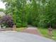 A long driveway lined with trees and brick columns leads to the property at 5588 Rhododendron Trl, Douglasville, GA 30135