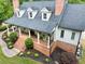 Classic home featuring dormer windows, a welcoming front porch with columns, and meticulously maintained landscaping at 5588 Rhododendron Trl, Douglasville, GA 30135