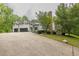 Exterior view of a well-manicured home and front yard with a three car garage at 5588 Rhododendron Trl, Douglasville, GA 30135