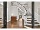 Elegant foyer with hardwood floors, staircase, and decorative chest creates a welcoming entrance at 5588 Rhododendron Trl, Douglasville, GA 30135