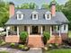 Charming two-story home featuring a brick foundation, inviting front porch with classic columns, and well-manicured landscaping at 5588 Rhododendron Trl, Douglasville, GA 30135