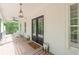 Welcoming front porch with stylish lighting, comfortable seating, and an inviting atmosphere with nature views at 5588 Rhododendron Trl, Douglasville, GA 30135