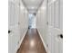 Hallway with stained hardwood floors and white doors at 5588 Rhododendron Trl, Douglasville, GA 30135