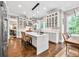 Well-lit kitchen with a white island, wooden floors, and stainless steel appliances at 5588 Rhododendron Trl, Douglasville, GA 30135
