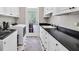 Well-lit laundry room featuring a sink, modern washer and dryer, and ample cabinetry at 5588 Rhododendron Trl, Douglasville, GA 30135