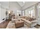 Spacious living room with vaulted ceiling, comfortable seating, and sunroom access offers relaxed living at 5588 Rhododendron Trl, Douglasville, GA 30135