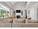 Spacious living room with vaulted ceiling, fireplace, and large windows providing abundant natural light at 5588 Rhododendron Trl, Douglasville, GA 30135