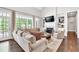 Bright living room with large windows, fireplace, and stylish furnishings offers a comfortable space at 5588 Rhododendron Trl, Douglasville, GA 30135