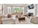 Bright living room with large windows, fireplace, and comfortable sectional sofa at 5588 Rhododendron Trl, Douglasville, GA 30135
