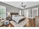 Main bedroom with grey walls, ceiling fan, and walk-in closet at 5588 Rhododendron Trl, Douglasville, GA 30135