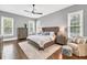 Main bedroom features grey walls, a ceiling fan, and lots of natural light at 5588 Rhododendron Trl, Douglasville, GA 30135