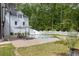 Relaxing backyard pool area featuring lounge chairs and a white picket fence at 5588 Rhododendron Trl, Douglasville, GA 30135