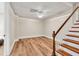 Stairway with hardwood steps, white railing, and access to lower level at 5588 Rhododendron Trl, Douglasville, GA 30135