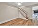 Stairway featuring hardwood steps, white railing, and access to upper level at 5588 Rhododendron Trl, Douglasville, GA 30135