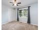 Cozy bedroom with neutral carpet, a double-door closet, and a window with backyard view at 2884 Bent Creek Nw Dr, Kennesaw, GA 30152