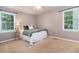Comfortable bedroom with two bright windows, soft carpet, and a ceiling fan at 2884 Bent Creek Nw Dr, Kennesaw, GA 30152