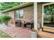 Cozy front porch with chairs and potted plants, complementing the brick exterior of the home at 2884 Bent Creek Nw Dr, Kennesaw, GA 30152