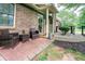 Inviting front porch with seating, potted plants, and brick walkway enhancing the home's exterior at 2884 Bent Creek Nw Dr, Kennesaw, GA 30152