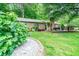 Inviting front yard with beautiful landscaping, a brick home, and a cozy patio area at 2884 Bent Creek Nw Dr, Kennesaw, GA 30152