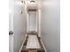 Long hallway with a decorative rug runner, neutral walls, and tiled flooring at 2884 Bent Creek Nw Dr, Kennesaw, GA 30152