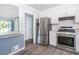 Modern kitchen featuring stainless steel appliances, ample cabinet space, and an open layout, perfect for cooking at 2884 Bent Creek Nw Dr, Kennesaw, GA 30152