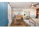 Open-concept living room featuring a sliding barn door, hardwood floors, and seamless flow to the dining and kitchen areas at 2884 Bent Creek Nw Dr, Kennesaw, GA 30152