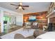 Bright living room showcasing a fireplace, wood accent wall, and an open layout connecting to the dining area at 2884 Bent Creek Nw Dr, Kennesaw, GA 30152
