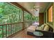Outdoor seating area on the spacious covered back porch with ceiling fan at 2910 Leeds Garden Ln, Alpharetta, GA 30022
