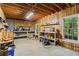 Unfinished basement featuring wood walls, exposed ceiling, and an abundance of storage and workspace at 2910 Leeds Garden Ln, Alpharetta, GA 30022