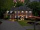 Charming two-story brick home with manicured lawn, blue shutters and a welcoming front entrance at 2910 Leeds Garden Ln, Alpharetta, GA 30022