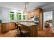 Bright kitchen featuring granite countertops, wood cabinets, stainless steel appliances, and a kitchen island with barstool seating at 2910 Leeds Garden Ln, Alpharetta, GA 30022