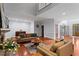 Open living room with fireplace, hardwood floors, and ample space for entertaining at 2910 Leeds Garden Ln, Alpharetta, GA 30022