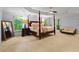 Spacious primary bedroom featuring a tray ceiling, four poster bed, and large windows with backyard views at 2910 Leeds Garden Ln, Alpharetta, GA 30022