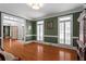 Well-lit office with crown molding, hardwood floors, and elegant window shutters at 2910 Leeds Garden Ln, Alpharetta, GA 30022
