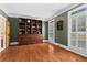 Stylish office with custom built-ins, hardwood floors, and plantation shutters at 2910 Leeds Garden Ln, Alpharetta, GA 30022