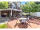 A brick patio with several tables and chairs with trees in the background at 2910 Leeds Garden Ln, Alpharetta, GA 30022