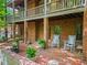 Patio with chairs, brick columns, and well-manicured landscaping at 2910 Leeds Garden Ln, Alpharetta, GA 30022