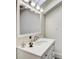 Bright bathroom with a white vanity, mirror, and modern lighting at 30 5Th Ne St # 1006, Atlanta, GA 30308