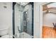 Modern bathroom featuring a glass-enclosed shower with blue tile accents at 30 5Th Ne St # 1006, Atlanta, GA 30308