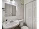 Clean bathroom with a pedestal sink, toilet, and mirrored cabinet at 30 5Th Ne St # 1006, Atlanta, GA 30308
