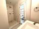 Modern bathroom featuring a glass shower, white marble walls, and a door to the bedroom at 30 5Th Ne St # 1006, Atlanta, GA 30308