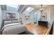 Bright bedroom featuring skylights, hardwood floors, and a view into the en-suite bathroom at 30 5Th Ne St # 1006, Atlanta, GA 30308