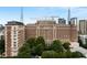 Exterior shot of a high-rise residential building with lush green landscaping at 30 5Th Ne St # 1006, Atlanta, GA 30308