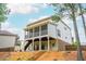 Back exterior of home featuring a screened porch, back yard access, basement level, and wooded view at 4840 Chase Ln, Cumming, GA 30040