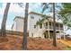 Home exterior, featuring a multilevel back porch, a fenced yard on a pine covered slope at 4840 Chase Ln, Cumming, GA 30040