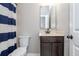 Bathroom featuring a vanity with sink, toilet, and shower with blue striped curtain at 4840 Chase Ln, Cumming, GA 30040