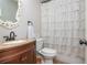 Charming bathroom with a decorative mirror, elegant vanity, and stylish shower curtain, adding a touch of sophistication at 4840 Chase Ln, Cumming, GA 30040