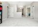 Large, neutrally painted and carpeted bonus room with several doorways leading into bedrooms or other areas at 4840 Chase Ln, Cumming, GA 30040